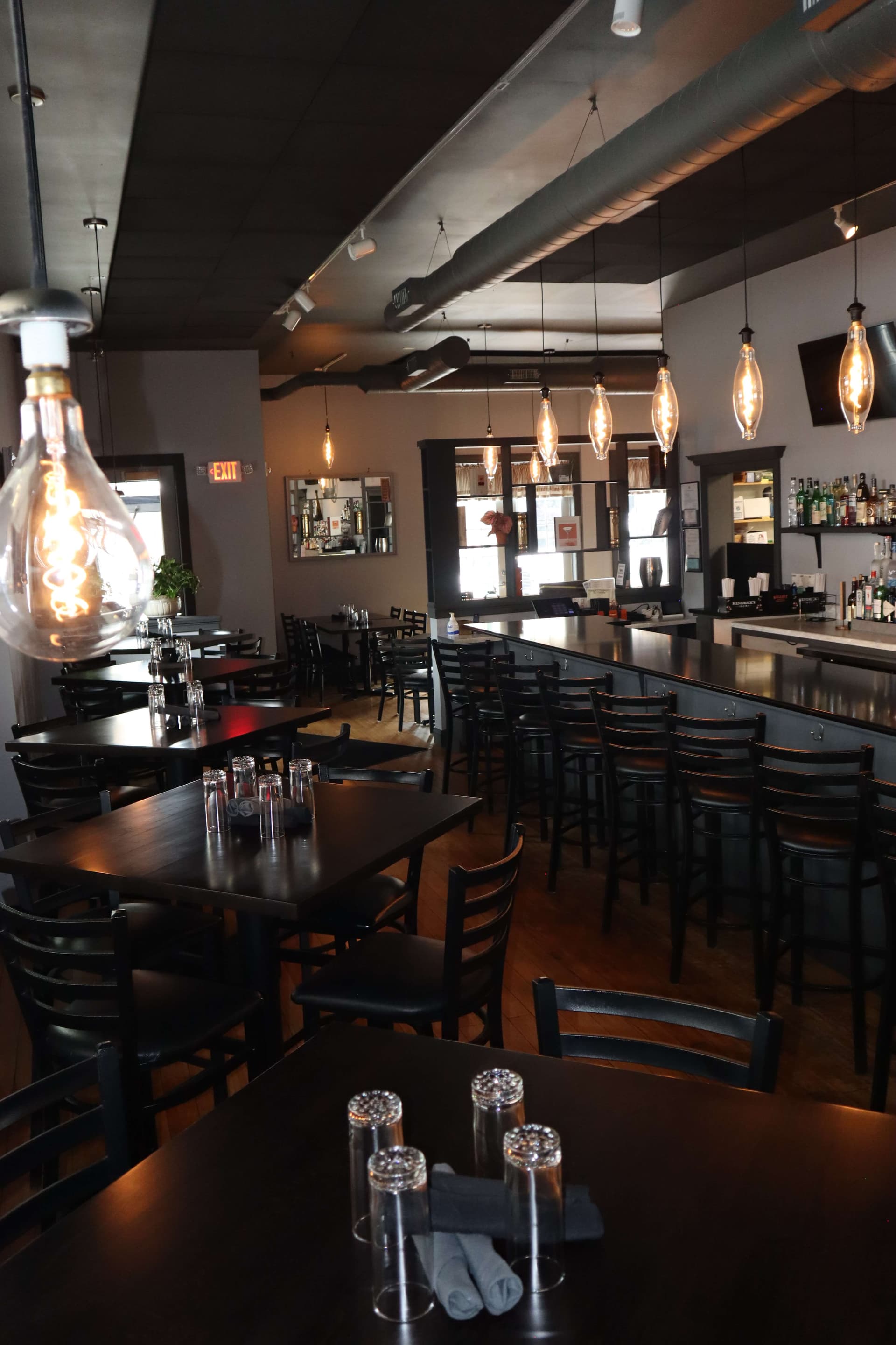 The Manhattan dining area with Edison bulb pendant lights