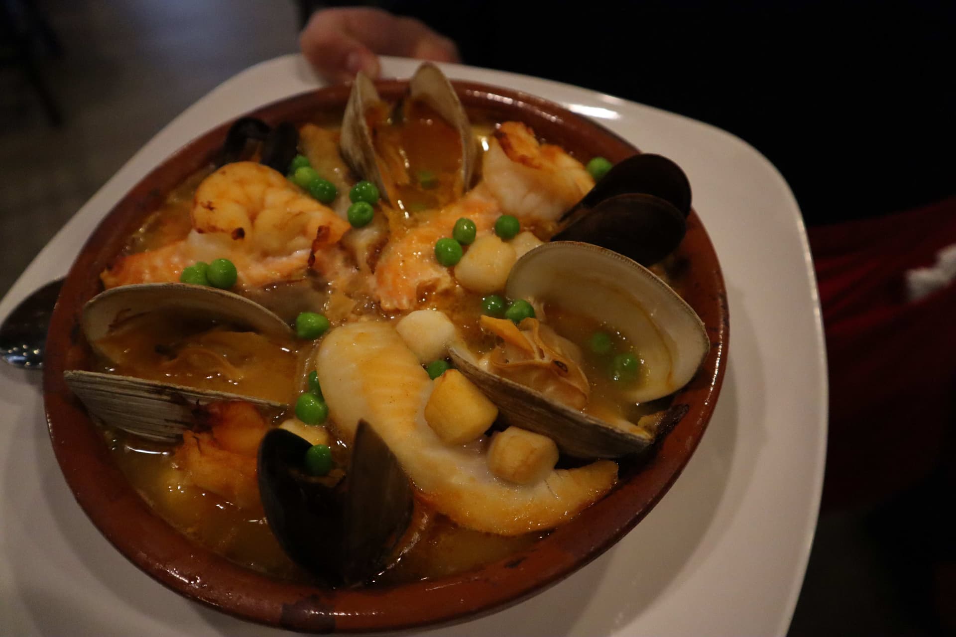 Traditional Spanish seafood paella in terracotta cazuela