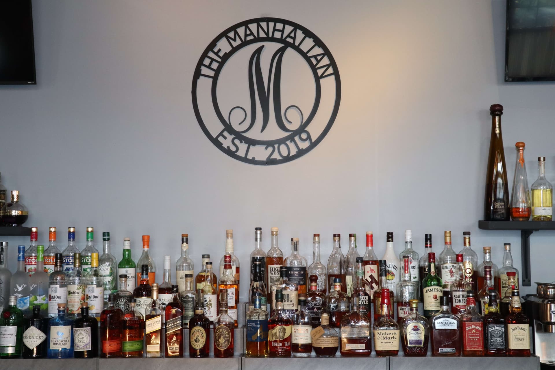 The Manhattan spirits display with logo
