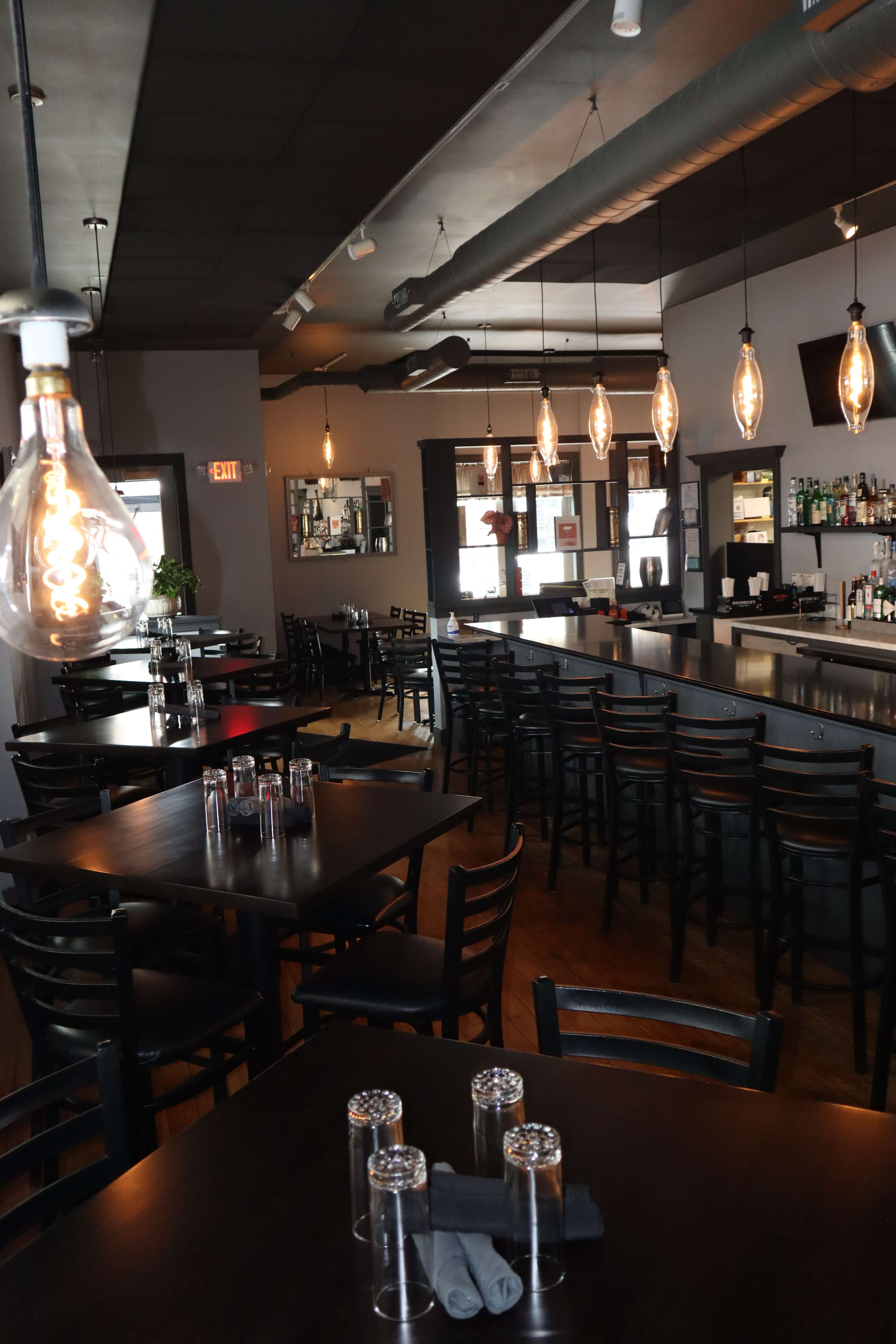 The Manhattan dining area with Edison bulb pendant lights