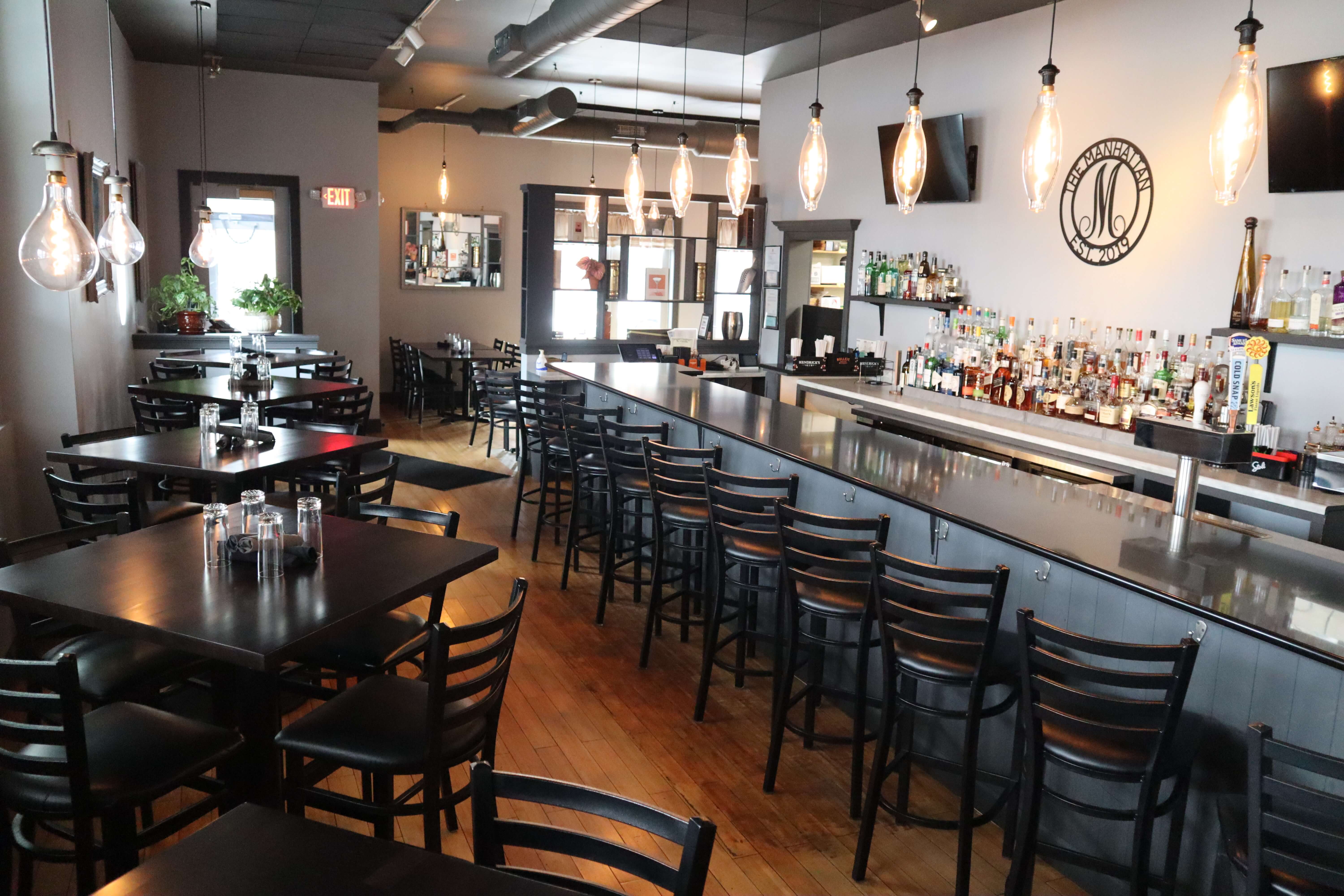 The Manhattan dining room and bar with Edison bulb pendant lights