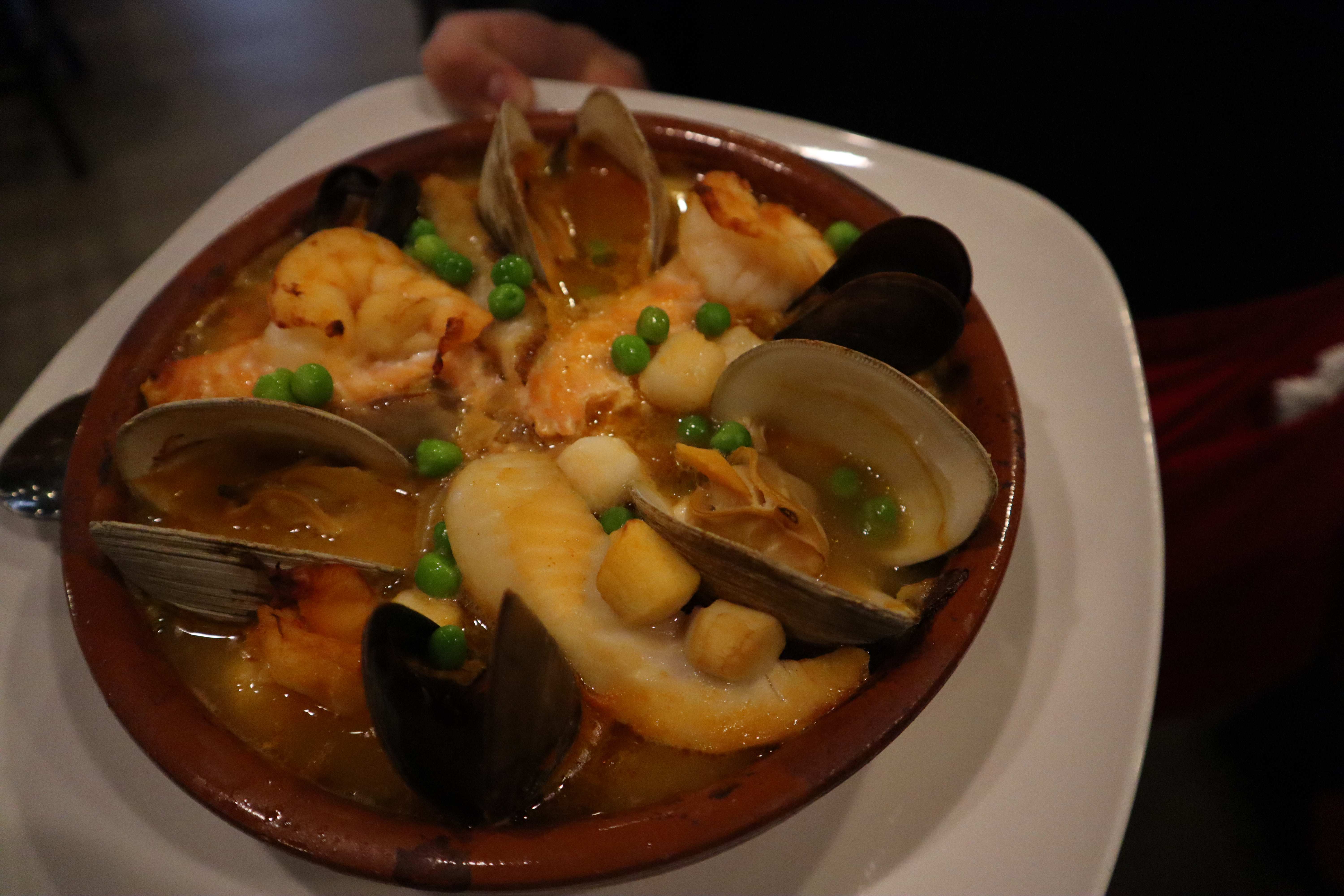 Traditional Spanish seafood paella in a terracotta cazuela